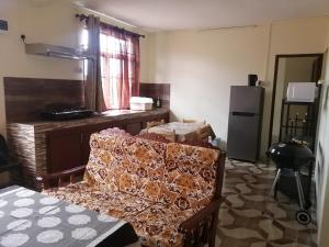 a living room with a couch and a refrigerator at Hortensia in Quatre Bornes +28 photos