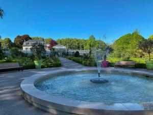 a fountain in the middle of a park with benches at Apartment house View Rotonde, Amiens in Amiens
