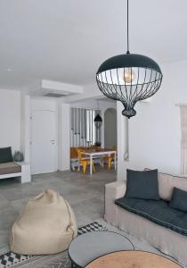 a living room with a couch and a chandelier at Elements Villas in Lardos