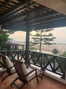 two chairs on a balcony with a view of the beach at Maison Simonetta in Oualidia +28 photos
