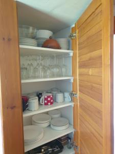 a cupboard filled with plates and cups and dishes at horská chata Cecilie in Olešnice v Orlických horách