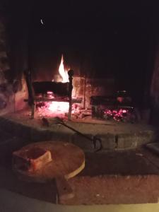 a fire oven with a table in front of it at Villa Dacia in Guiglia