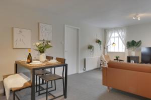 a living room with a table and a couch at Springvale in Sheffield