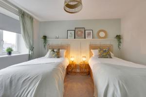 two beds sitting next to each other in a bedroom at Springvale in Sheffield
