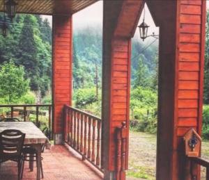 a screened in porch with a table and a view of the mountains at Zilkale Butik Otel in Çamlıhemşin +40 photos