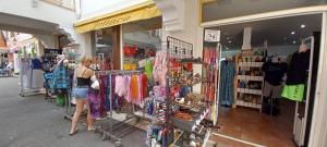 a woman standing in front of a clothing store at Village Cap Estérel Agay St Raphaël vue mer et piscine in Agay - Saint Raphael
