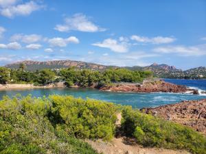 a view of a river with mountains in the background at Village Cap Estérel Agay St Raphaël vue mer et piscine in Agay - Saint Raphael