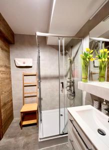 a bathroom with a shower and a sink at Apartament SPA 04 Resort Kozubnik blisko Szczyrk - 5D Apartamenty in Porąbka