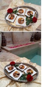 マラケシュにあるダル アル スルタンのバラのテーブルの上に食料品のトレイ