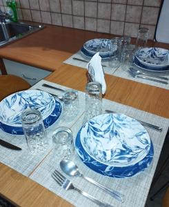 a table with blue and white plates and glasses on it at Casa D' Irene in Karpenisi