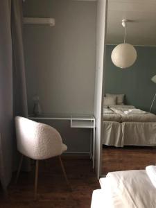 a room with a desk and a chair and a bed at Lovely two room unit with free parking in Kuopio