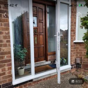 a front door of a house with a potted plant at Bramcote 3 bedroom house in Bramcote