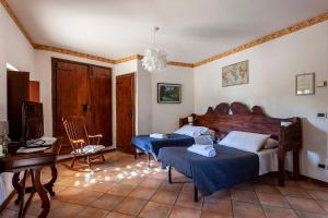 ein Schlafzimmer mit zwei Betten, einem Schreibtisch und einem Fernseher in der Unterkunft Rovere dalla riva in Arzene