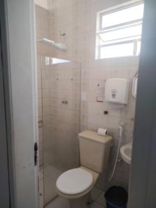 a bathroom with a toilet and a sink at Maré Hostel Itapuã in Salvador