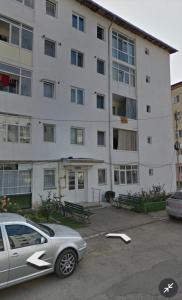 a car parked in a parking lot in front of a building at Breaza Comfort Apartment in Breaza