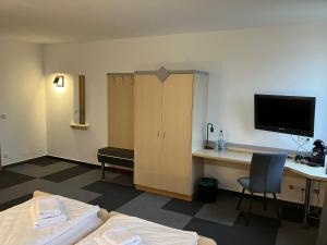 a hotel room with a desk and a bed and a computer at Room-24 - Zellwald in Großschirma
