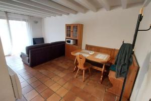 a living room with a table and a couch at T1 Proche Annecy in Épagny