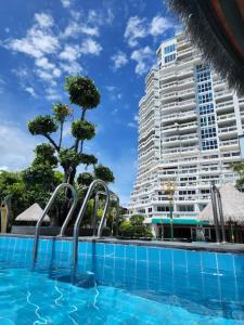 a swimming pool in front of a large building at Andaman sea view private in Patong Beach