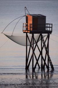 un bateau assis sur l'eau avec un filet dans l'établissement le chalet de laura, à Pornic