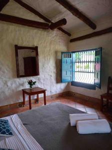 a bedroom with a bed and a window and a table at Casa Benigno muy cerca de Ginebra in Ginebra