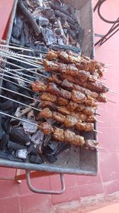 a bunch of food being cooked on a grill at La Fibule D'or in Aït Benhaddou