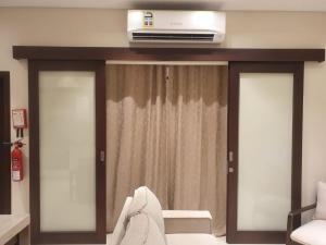 a living room with a tv on top of a window at Forest Island apartment in Salalah in Salalah