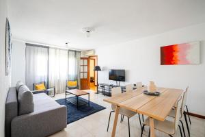 a living room with a couch and a table at MODERN AND BRIGHT APARTMENT Plaza Elíptica -MAGIN in Madrid