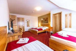 Postelja oz. postelje v sobi nastanitve Hotel Bau Maribor