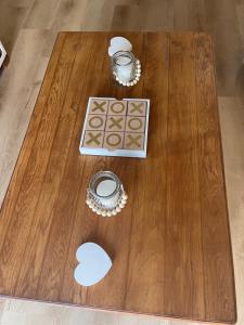 a wooden table with two items on top of it at Adorable 2 Bedroom Cottage with spacious veranda in Hermanus