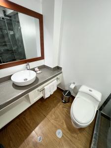 a bathroom with a white toilet and a sink at Hotel Andes Urubamba by Ämak in Urubamba +90 photos
