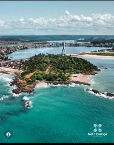 an island in a body of water with a bridge at kitnet pé na areia reservado por sayonara in Ilhéus +14 photos