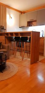 a kitchen with a large wooden table in a room at Apartment U245 in aparthotel Vucko - private host in Jahorina +8 photos