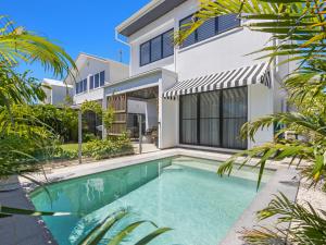 a swimming pool in front of a house at Sea Spray by Kingscliff Accommodation in Kingscliff