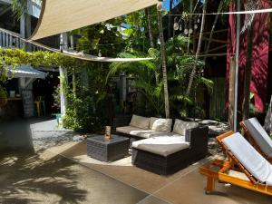 a patio with two couches and a swing at El Reinas by Sugar's Monkey in Playa Grande