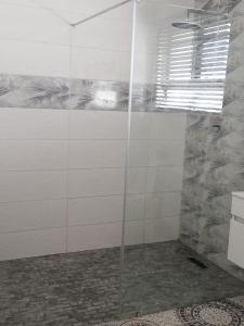 a shower with a glass door in a bathroom at Beach blessing in Gansbaai