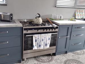a kitchen with a stove with a pot on it at Beach blessing in Gansbaai