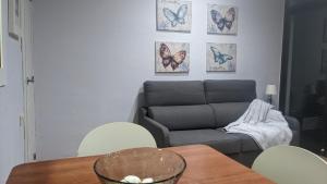 a living room with a couch and a table and chairs at Arran de Mar Cambrils in Cambrils