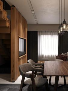 a dining room with a wooden table and chairs at Woodside Duplex Apartment Ski in Ski out with garage in Kopaonik