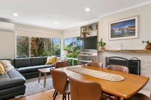阿波罗湾Miren Cottage Holiday Home Free Wi-Fi的客厅里有一张桌子和一张沙发 更多6张照片