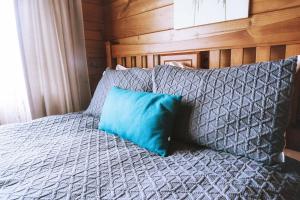 a blue pillow sitting on top of a bed at Comfortable Cosy Retreat in Rotorua