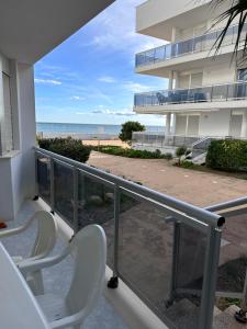 two chairs on a balcony with a view of the beach at Riviera Mont Roig Del Camp in Tarragona