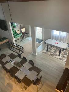 un tavolo e sedie in un soggiorno con tavolo e pianoforte di Modern Home near Lake w HotTub, Game Room, Fireplace a Albrightsville