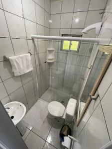 a small bathroom with a toilet and a sink at Moradas Dona Dalcema in Guarda do Embaú +59 photos