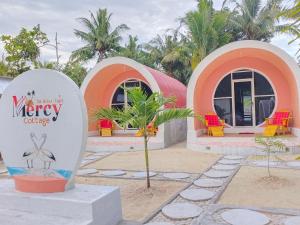 a building with a surfboard in front of it at Mercy Cottage in Langgur