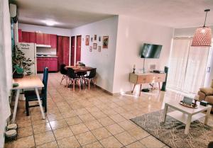 a living room with a kitchen and a dining room at Salinas House - The World’s favorite stay! in Salinas