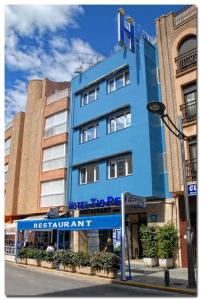 a blue building with a sign in front of it at Hotel Tio Pepe in Peñíscola