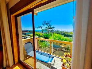 a balcony with a chair and a view of the ocean at Casa da Amorosa com Vista Mar by Lethes Legacy in Abelheira