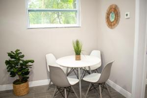 a white dining room with a white table and chairs at Boho Chic Cosy Home In The Heart Of Tampa And Ybor in Tampa