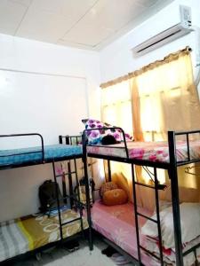 a room with three bunk beds and a window at C&CHappyStayPhilippines Metropolitan Tower, 1746 A Mabini st, Malate Manila, Unit # 1104 in Manila