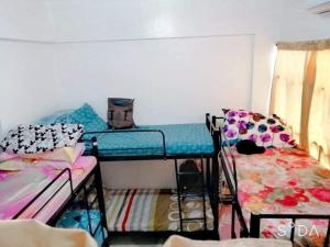 a dorm room with two bunk beds and a bed at C&CHappyStayPhilippines Metropolitan Tower, 1746 A Mabini st, Malate Manila, Unit # 1104 in Manila